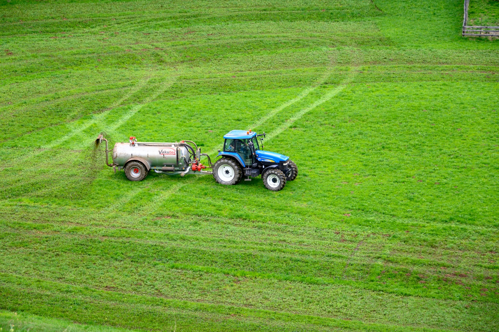 brown tractor on green grass field